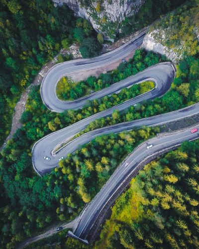 aerial view of road in the middle of forest